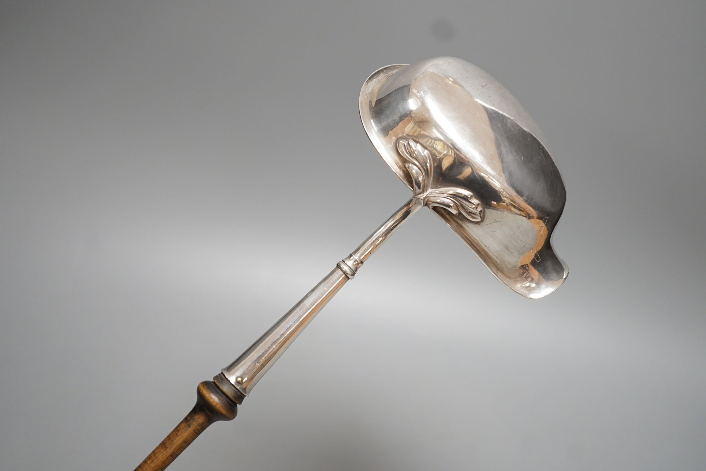 A Swedish? white metal punch ladle, with turned wooden handle, 42.5cm.